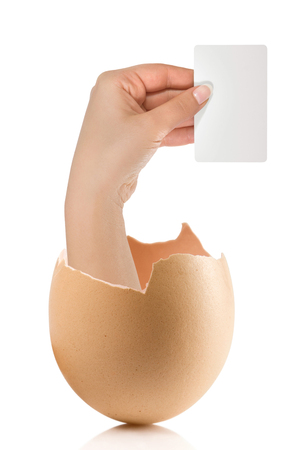 Hand with broken egg isolated on white backroundの写真素材