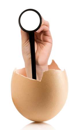 Hand with broken egg isolated on white backroundの写真素材
