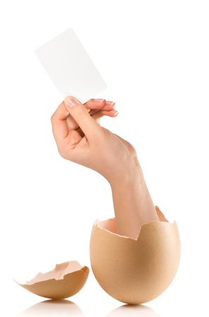 Hand with broken egg isolated on white backroundの写真素材