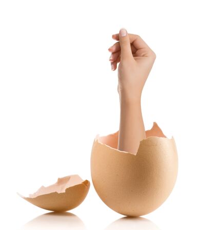 Hand with broken egg isolated on white backroundの写真素材