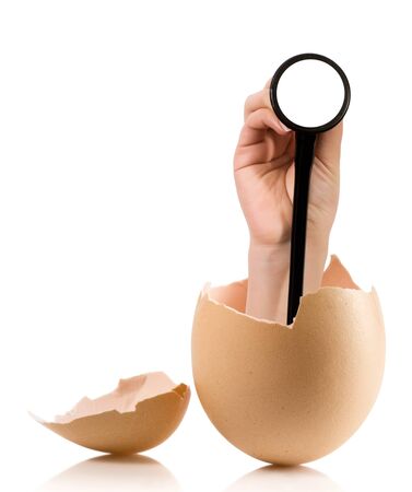 Hand with broken egg isolated on white backroundの写真素材