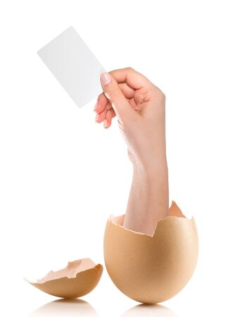 Hand with broken egg isolated on white backroundの写真素材