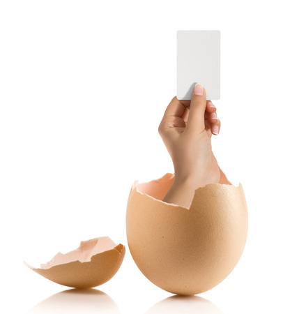 Hand with broken egg isolated on white backroundの写真素材