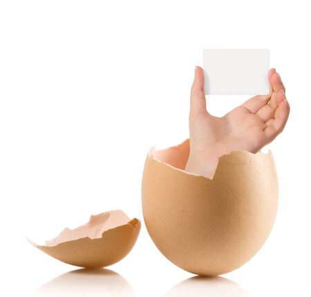 Hand with broken egg isolated on white backroundの写真素材