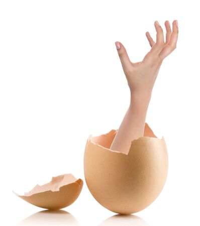 Hand with broken egg isolated on white backroundの写真素材