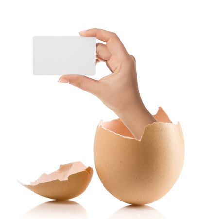 Hand with broken egg isolated on white backroundの写真素材