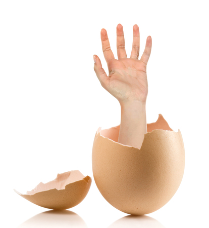 Hand with broken egg isolated on white backroundの写真素材