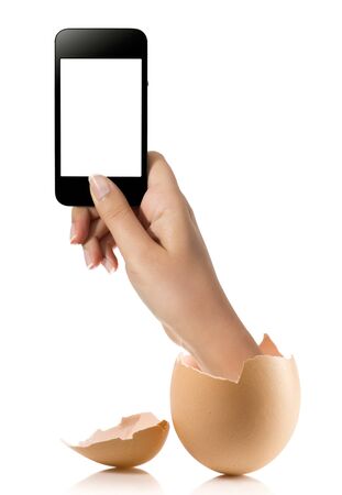 Hand with broken egg isolated on white backround. Hand of young man holding smart phone white screen isolated on white background with clipping pathの写真素材