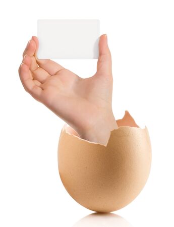 Hand with broken egg isolated on white backroundの写真素材