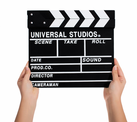 Hands holding a clapper board.Isolated on white backroundの写真素材