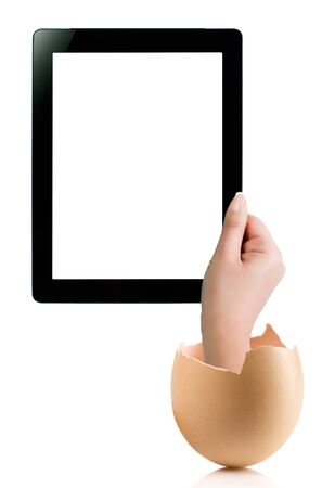 Hand holding a tablet computer with white screen. Hand with broken egg isolated on white backround. Hand holding tablet pc isolated on white background with blank screen.の写真素材
