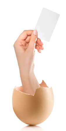 Hand with broken egg isolated on white backroundの写真素材