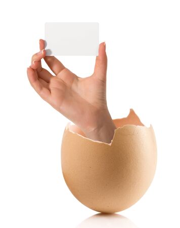 Hand with broken egg isolated on white backroundの写真素材