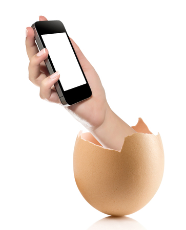 Hand with broken egg isolated on white backround. Hand of young man holding smart phone white screen isolated on white background with clipping pathの写真素材