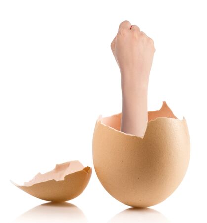 Hand with broken egg isolated on white backroundの写真素材
