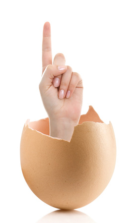 Hand with broken egg isolated on white backround. Woman index finger isolated on white backgroundの写真素材