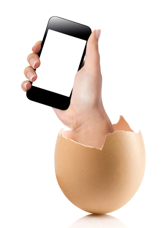 Hand with broken egg isolated on white backround. Hand of young man holding smart phone white screen isolated on white background with clipping pathの写真素材