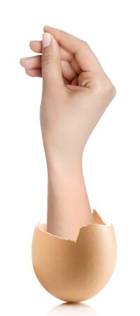 Hand with broken egg isolated on white backroundの写真素材