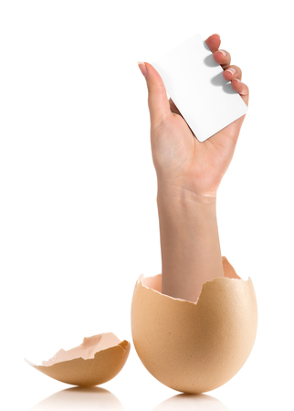 Hand with broken egg isolated on white backroundの写真素材