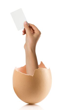 Hand with broken egg isolated on white backroundの写真素材