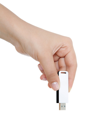 Female hand holding usb stick isolated on whiteの写真素材