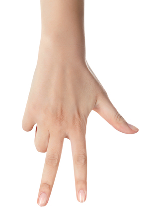 Hand showing the sign of victory and peace. Close up of female hand showing victory sign isolated on white background. Woman hand gesturing peace sign.の写真素材