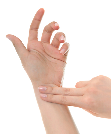 Female hand checking pulse on white background.の写真素材