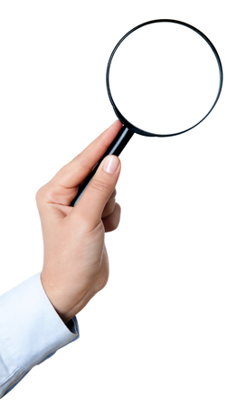 Female hand holding the magnifying glass isolated on white backgroundの写真素材