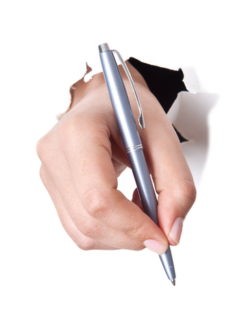 Hand writing on copy space. Beautiful female hand holding black marker pen . Brightly lit with backlight and isolated on white background.の写真素材