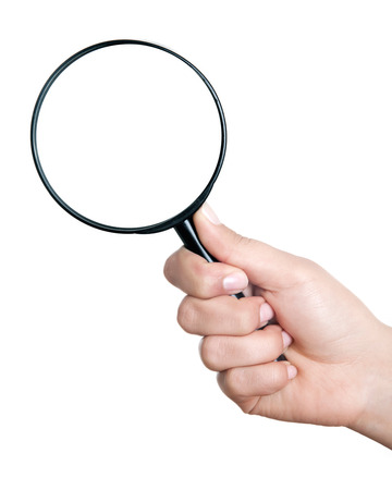 Female hand holding the magnifying glass isolated on white backgroundの写真素材