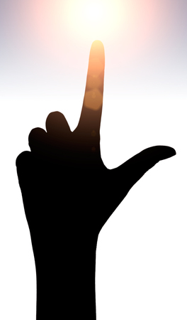 Raised hands catching sun on sunset sky. Concept of spirituality, wellbeing, positive energy etc.の写真素材