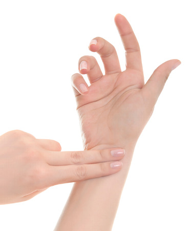 Female hand checking pulse on white background.の写真素材