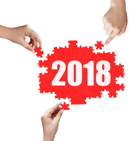 hand holding a piece of 2018 puzzleの写真素材