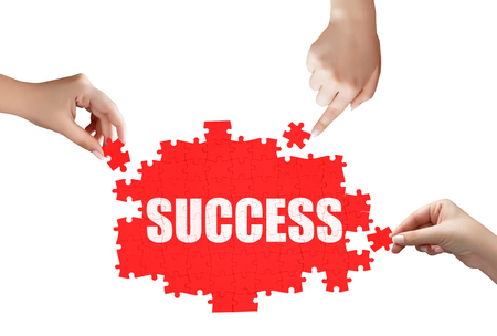 hand holding a piece of white success puzzleの写真素材