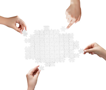 hand holding a piece of white uncompleted puzzleの写真素材