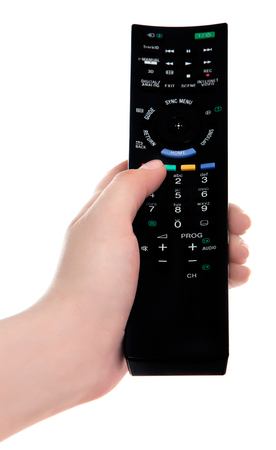hand with tv remote control isolated on white backgroundの写真素材