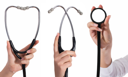 Doctor's hands holding stethoscope.Studio shot isolated on whiteの写真素材