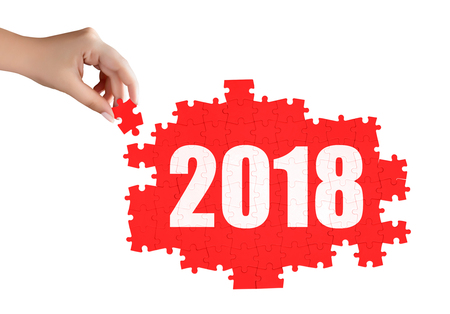 hand holding a piece of 2018 puzzleの写真素材