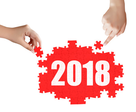 hand holding a piece of 2018 puzzleの写真素材