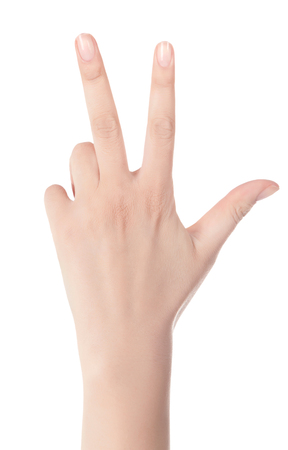 Hand showing the sign of victory and peace. Close up of female hand showing victory sign isolated on white background. Woman hand gesturing peace sign.の写真素材