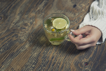 Cup of tea with thyme herb and lemon slicesの写真素材