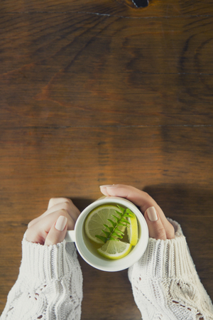 Cup of tea with thyme herb and lemon slicesの写真素材