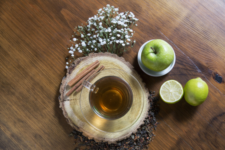 Food background with different black and green dry tea, rose buds cup of hot tea and iron teapot over dark wooden background. Tea drinking concept. Top view. Square imageの写真素材