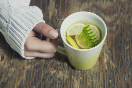 Cup of tea with thyme herb and lemon slicesの写真素材
