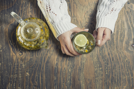 Cup of tea with thyme herb and lemon slicesの写真素材