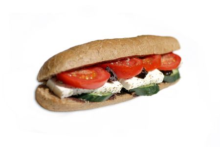 Sandwich in brown baquette with fetta cheese,tomato ,cucumber and olive paste.の写真素材