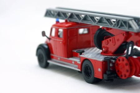 red fire truck toy over white background