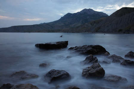 Evening over Black sea nad stones in the waterの写真素材