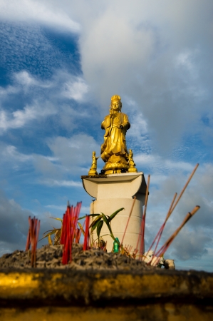 standing golden Guanyin with blueskyの写真素材