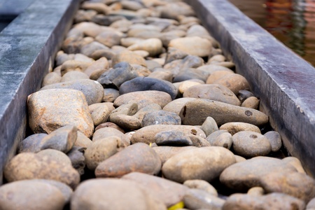 Straight pebble path on the edge of pondの写真素材
